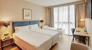Cama o camas de una habitación en Sercotel Cornellà Barcelona