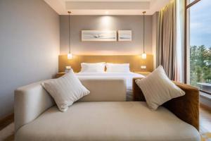 Letto o letti in una camera di Chengdu Flowing Strings peninsula boutique hotel-Near the Sichuan Cuisine Museum