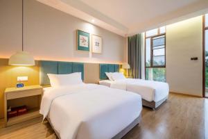 Letto o letti in una camera di Chengdu Flowing Strings peninsula boutique hotel-Near the Sichuan Cuisine Museum