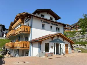a large white building with wooden balconies on it at Landhaus Cornelia in Berwang