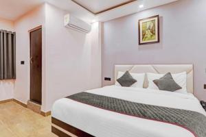 ラクナウにあるRROOMS Hotel Riddhi Regencyの部屋にある大きな白いベッドのある寝室