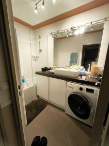 a bathroom with a sink and a washing machine at Le Clichy - 4 people - Metro 13 & 14 - Paris in Clichy +10 photos
