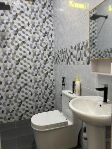 a bathroom with a toilet and a sink at Homestay Rakyat Dungun in Dungun +76 photos
