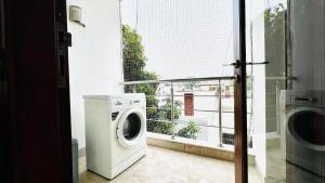 a washing machine in a room with a window at BluO 3BHK Safdarjung Enclave, Lift & Terrace Garden in New Delhi +13 photos