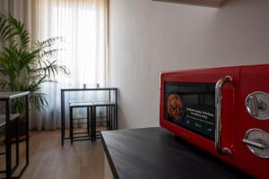a red toaster oven sitting on a table in a room at New Roman Experience in Rome