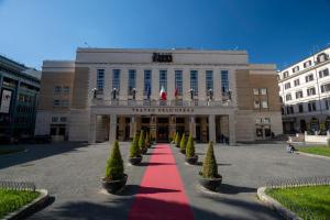 a building with a red carpet in front of it at New Roman Experience in Rome