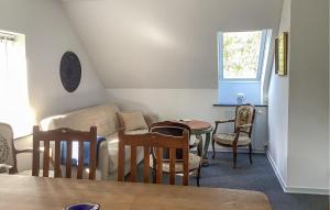 a living room with a couch and a table and chairs at 3 Bedroom Lovely Apartment In Engesvang in Engesvang