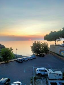 a parking lot with cars parked in front of the ocean at Loft House in Pizzo