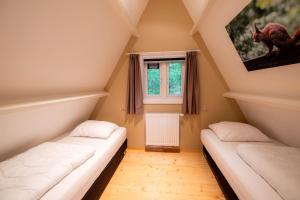 two beds in a room with a window at Hidden jewel in Durbuy's forest in Durbuy +24 photos