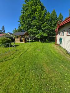 a large yard with a gazebo in the grass at Revontulet zohar hazfoni in Mikkeli