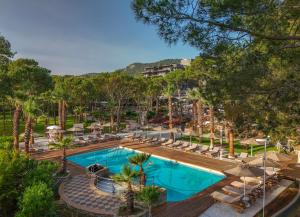 an overhead view of a swimming pool with lounge chairs at Balmy Foresta in Beldibi