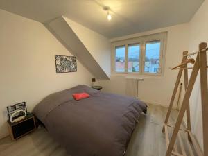 a bedroom with a large bed and a ladder at Maison lumineuse avec jardin & parking clos in Cucq