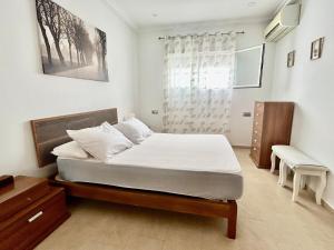 a bedroom with a bed and a dresser and a window at Modern 3-Bedroom Villa with Private Pool & BBQ in Cádiz