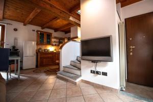 a living room with a flat screen tv on a wall at Comodità a due passi dal lago in Verbania