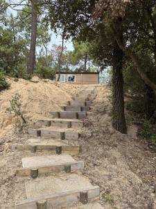 a set of stairs in the middle of a hill at Le Domaine des Pins in Saint-Hilaire-de-Riez