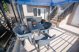 a patio with a table and chairs on a balcony at Villa DukiBalo in Ohrid