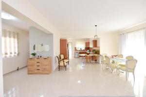 a kitchen and dining room with a table and chairs at Seraina House in Pastida +32 photos