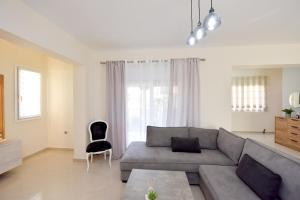 a living room with a couch and a chair at Seraina House in Pastida