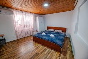 a bedroom with a bed with two swans on it at Villa DukiBalo in Ohrid +9 photos
