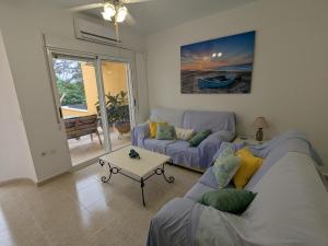 a living room with a couch and a table at Tu lugar feliz al lado del mar in Mazarrón +49 photos