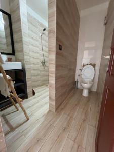 a bathroom with a toilet and a sink and a shower at Eco Stay by Ocean Sea View Apartment near Souss Massa National Park in Rbat +13 photos