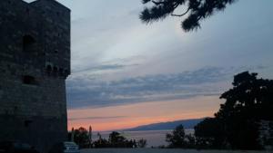 a building with a sunset in the background at Jasmina in Senj
