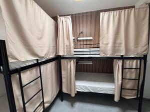 a couple of bunk beds in a room with a sink at Orange Terrace Hostel in Albufeira