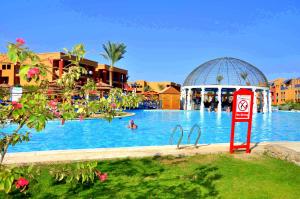 a swimming pool at a resort with a no swimming sign at Titanic Palace in Hurghada