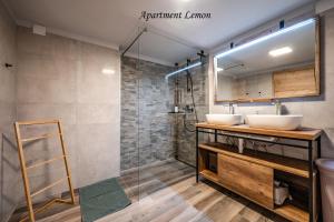 a bathroom with two sinks and a shower at Istrska kamnita hiša z velikim vrtom - Istrian Stone House with Big Garden in Marezige