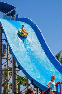 a couple of people riding a water slide at a water park at Titanic Palace in Hurghada
