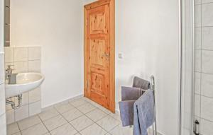 a bathroom with a sink and a wooden door at Ferienwohnung Ankershagen in Friedrichsfeld