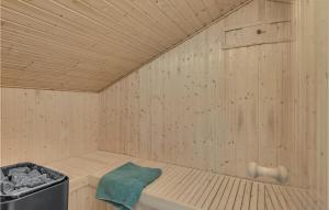 a wooden sauna with a green towel in it at Holiday Home Højdevej in Vejby