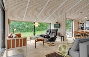 a living room with a couch and chairs and a table at Holiday Home Højdevej in Vejby