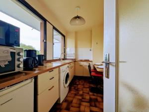 a kitchen with a sink and a washing machine at Budget apart with balcony in Saint-Denis