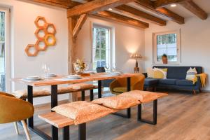 a living room with a wooden table and chairs at Waldfrieder Ferienwohnungen in Lauterbach