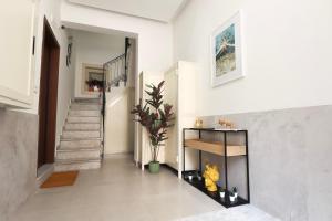 a hallway of a home with stairs and a fireplace at Appartamenti centro città Downtown Aitne in Catania