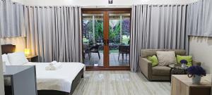 a hotel room with a bed and a couch at Denika's Suites in Puerto Princesa City +23 photos