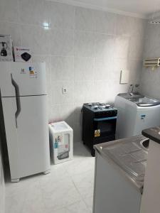 a kitchen with two refrigerators and a sink at Apto 2 quarto Completo com Vaga in Contagem