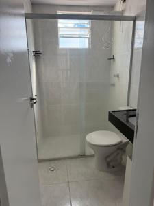 a bathroom with a shower and a toilet at Apto 2 quarto Completo com Vaga in Contagem