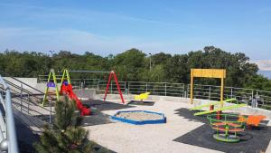 a playground with colorful play equipment in a park at Jasmina in Senj