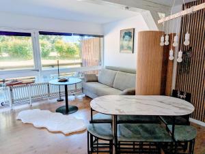 a living room with a couch and a table at Gemütliche Ferienwohnung in den Bergen in Siegsdorf
