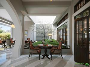 a patio with a table and chairs in a building at Koji in Ấp Ngọc Hải