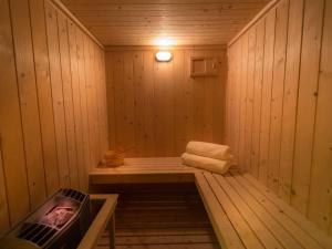 a sauna with a bench and a tv in it at Grand Mercure Majlis Residences in Abu Dhabi
