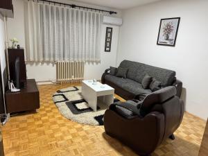 a living room with a couch and a table at Centar Sweet Home in Šabac