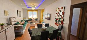 a living room with a couch and a table and chairs at Superbe apartment en residence with pool in Cabo Negro