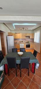 a dining room with a table and chairs and a kitchen at Superbe apartment en residence with pool in Cabo Negro