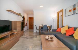 a living room with a couch and a table at Awesome Apartment In Benalmadena in Benalmádena
