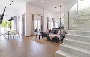 a living room with a couch and a staircase at Villa Esperanza in Canillas de Albaida
