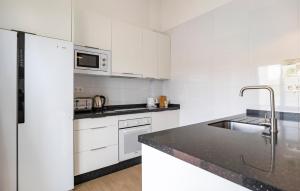 a white kitchen with a sink and a refrigerator at Villa Esperanza in Canillas de Albaida