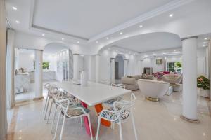a white dining room with a white table and chairs at Vale Do Lobo Resort in Vale do Lobo